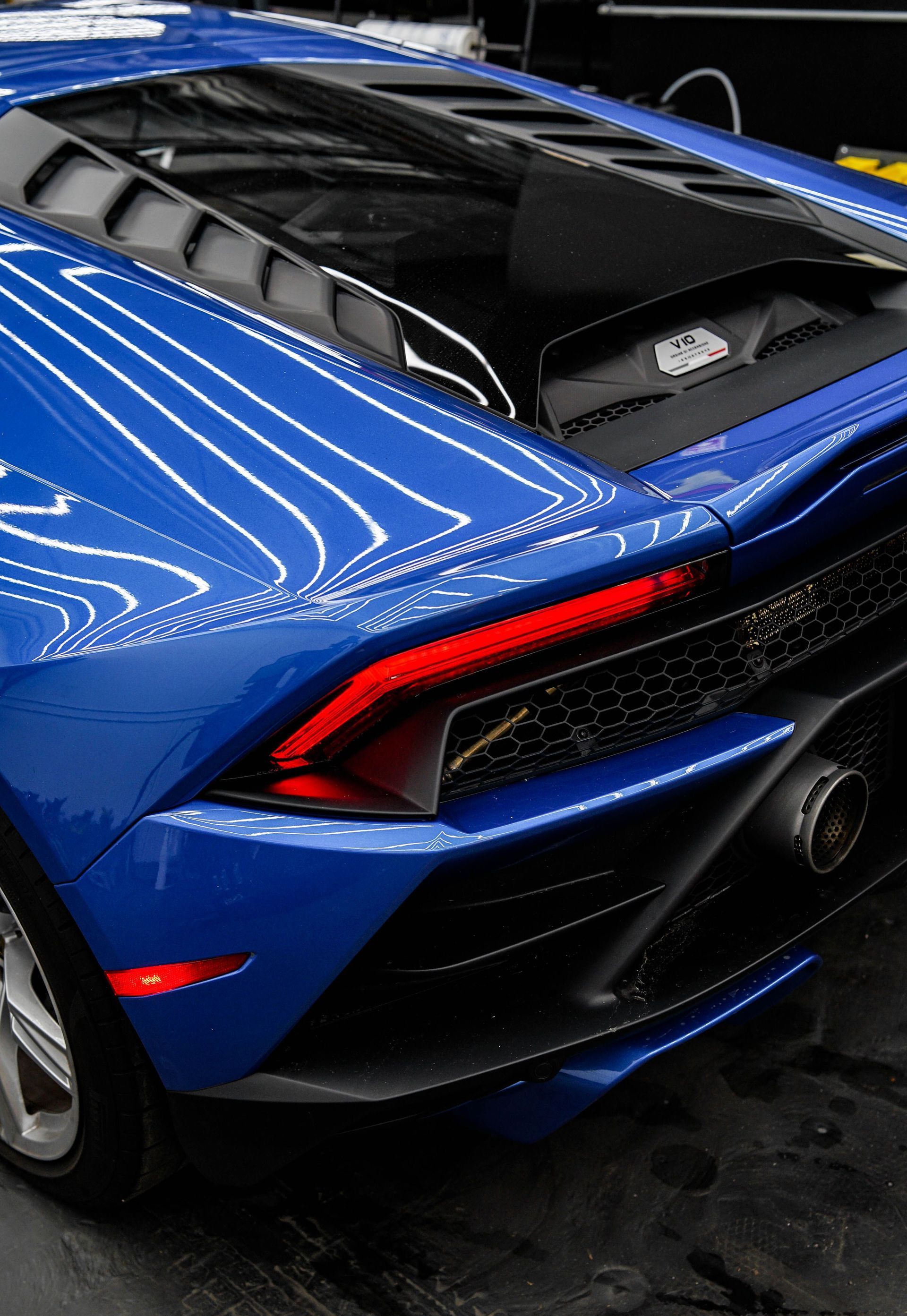 Close-up of a blue Lamborghini Huracan's rear, showcasing its sleek design and detailing.