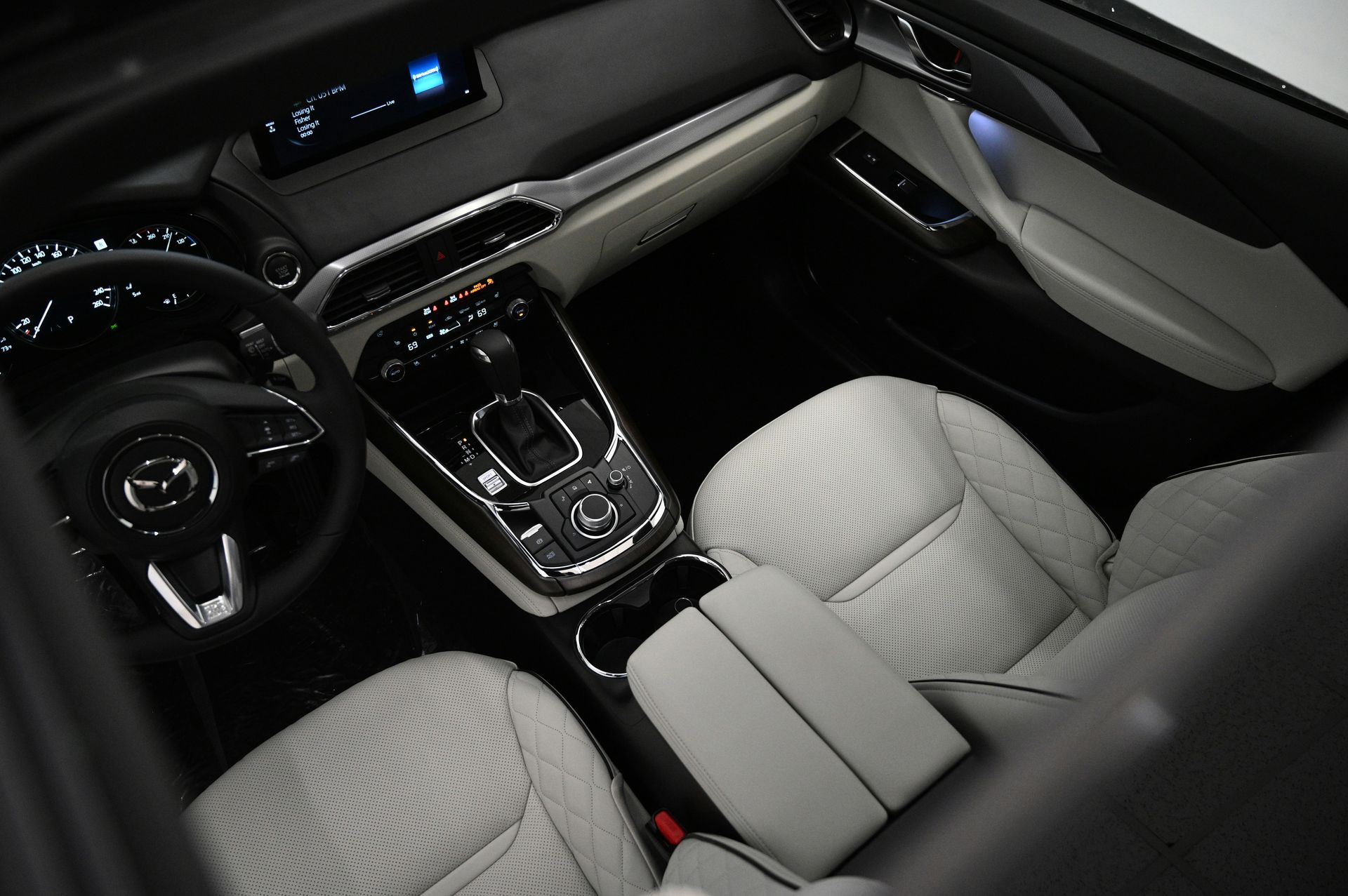 the interior of a car with a steering wheel and dashboard